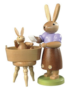 Easter bunny, female with little child have a bath