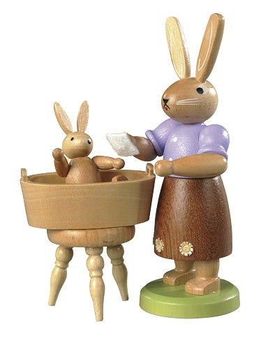 Easter bunny, female with little child have a bath