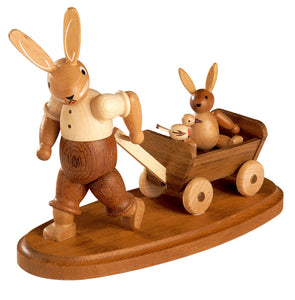 Easter bunny, male with child on wooden handcart