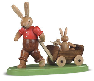Easter bunny, male with child on wooden handcart