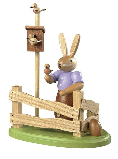 Easter bunny, female at garden fence